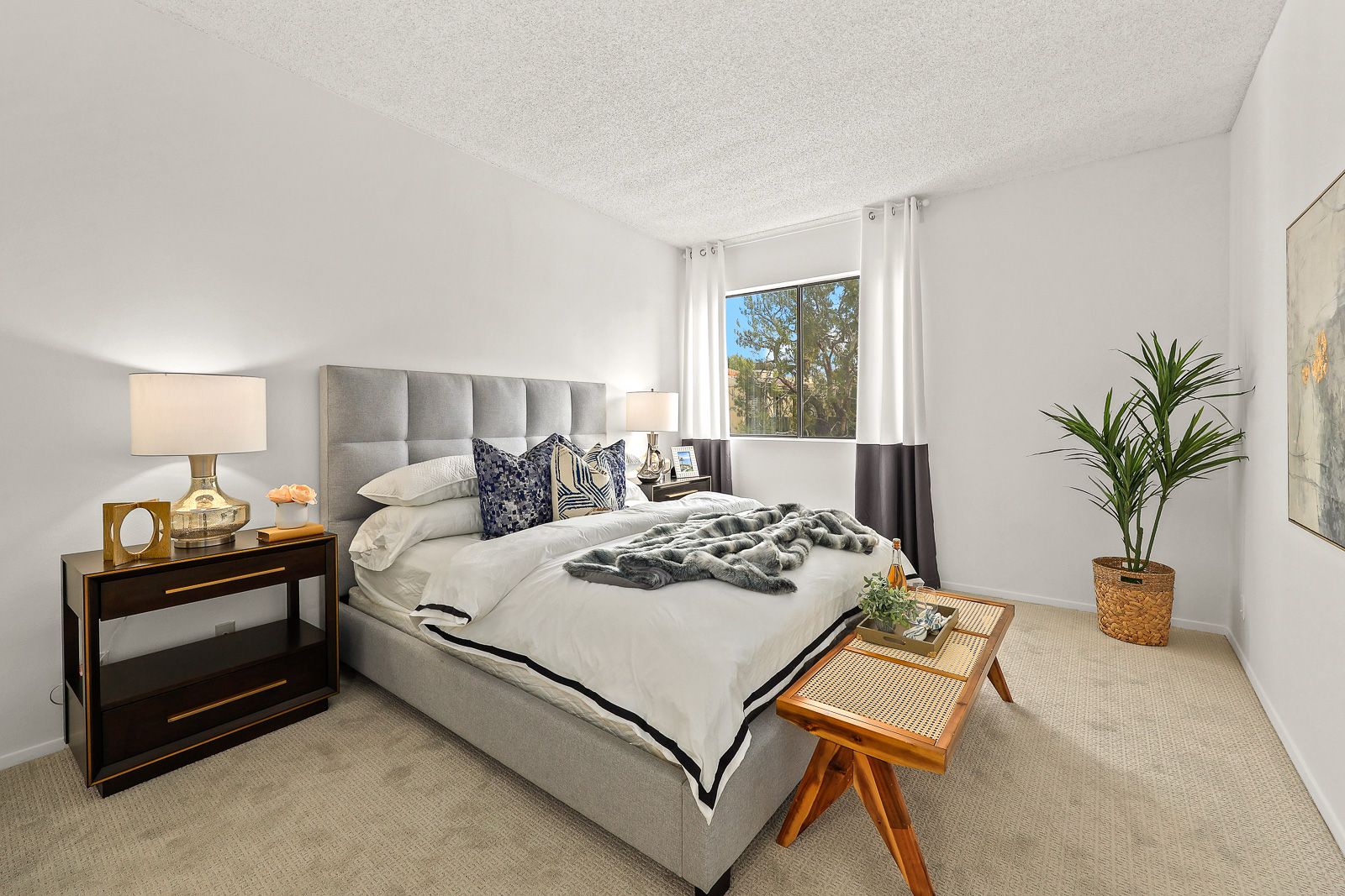 Staged bedroom with upholstered headboard — home staging