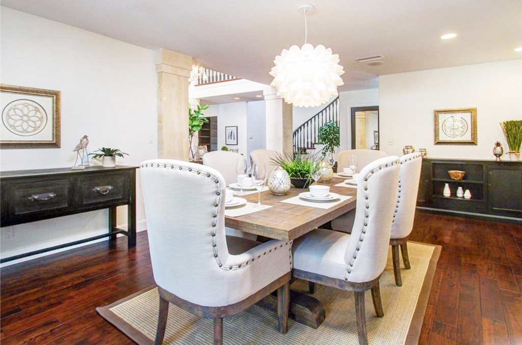 Staged formal dining room with dark hardwood floors — home staging