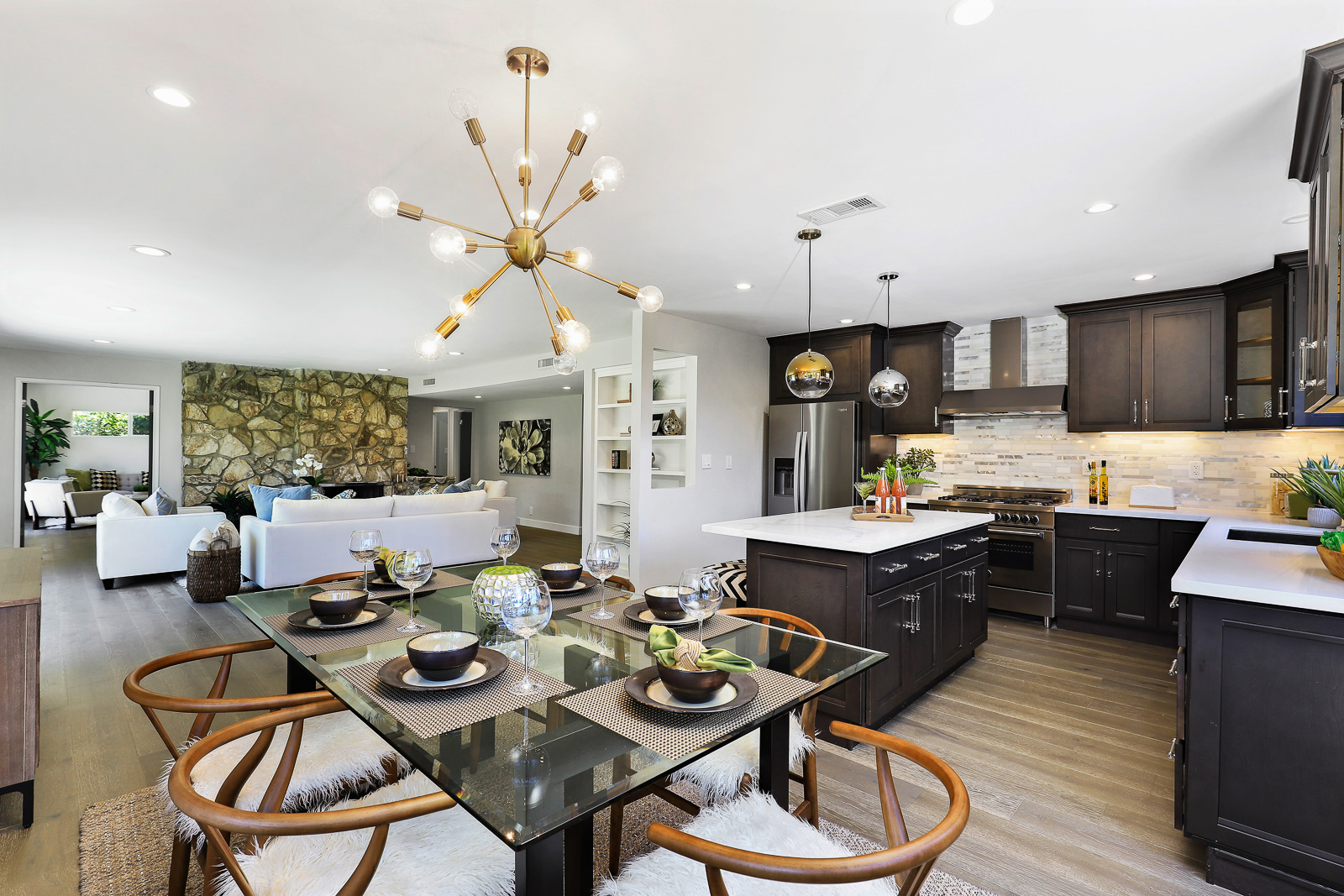 Staged kitchen and dining with dark cabinets — home staging