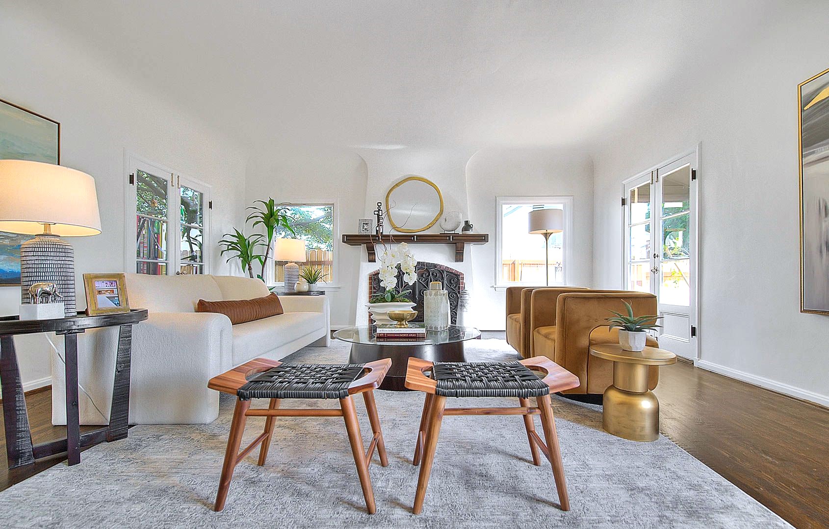 Wide-angle staged living room with mantel — home staging