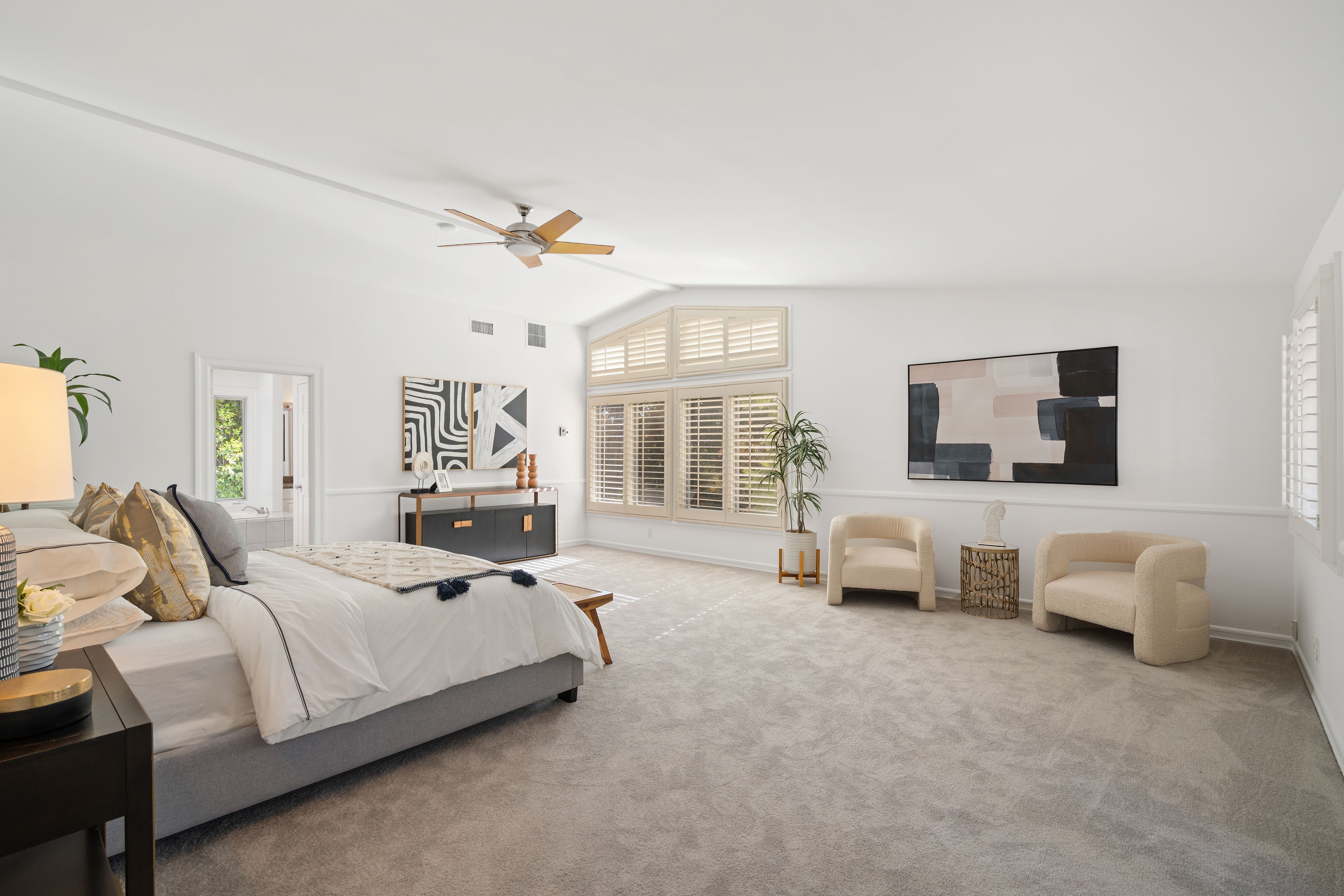 Staged master bedroom with shutters — home staging for real estate